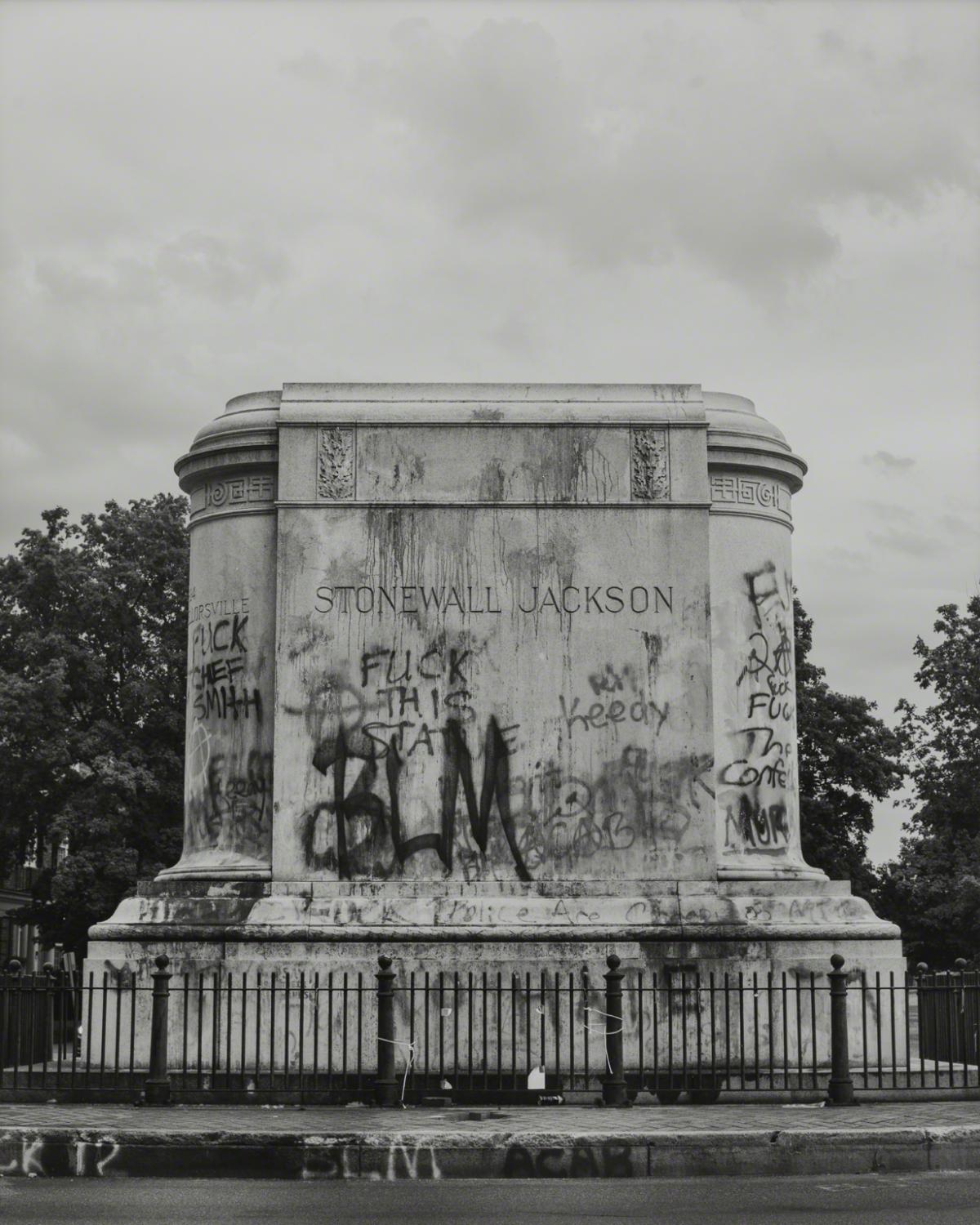 Black and white photograph of graffiti covered pedestal of now removed "Stonewall" Jackson statue Richmond, VA