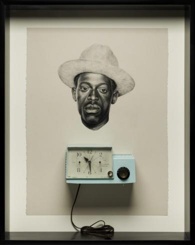 A blue clock sits underneath a portrait of a black man in a hat.