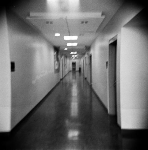 Black and white image of an empty hallway 