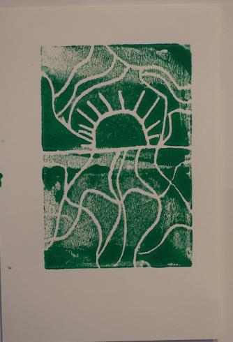 Green print of the sun and lines swirling around it.