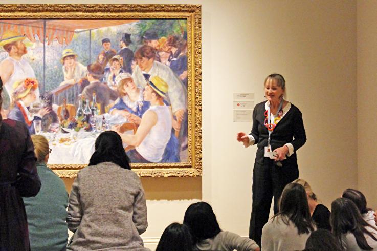 Students engaging with Renoir's Luncheon of the Boating Party