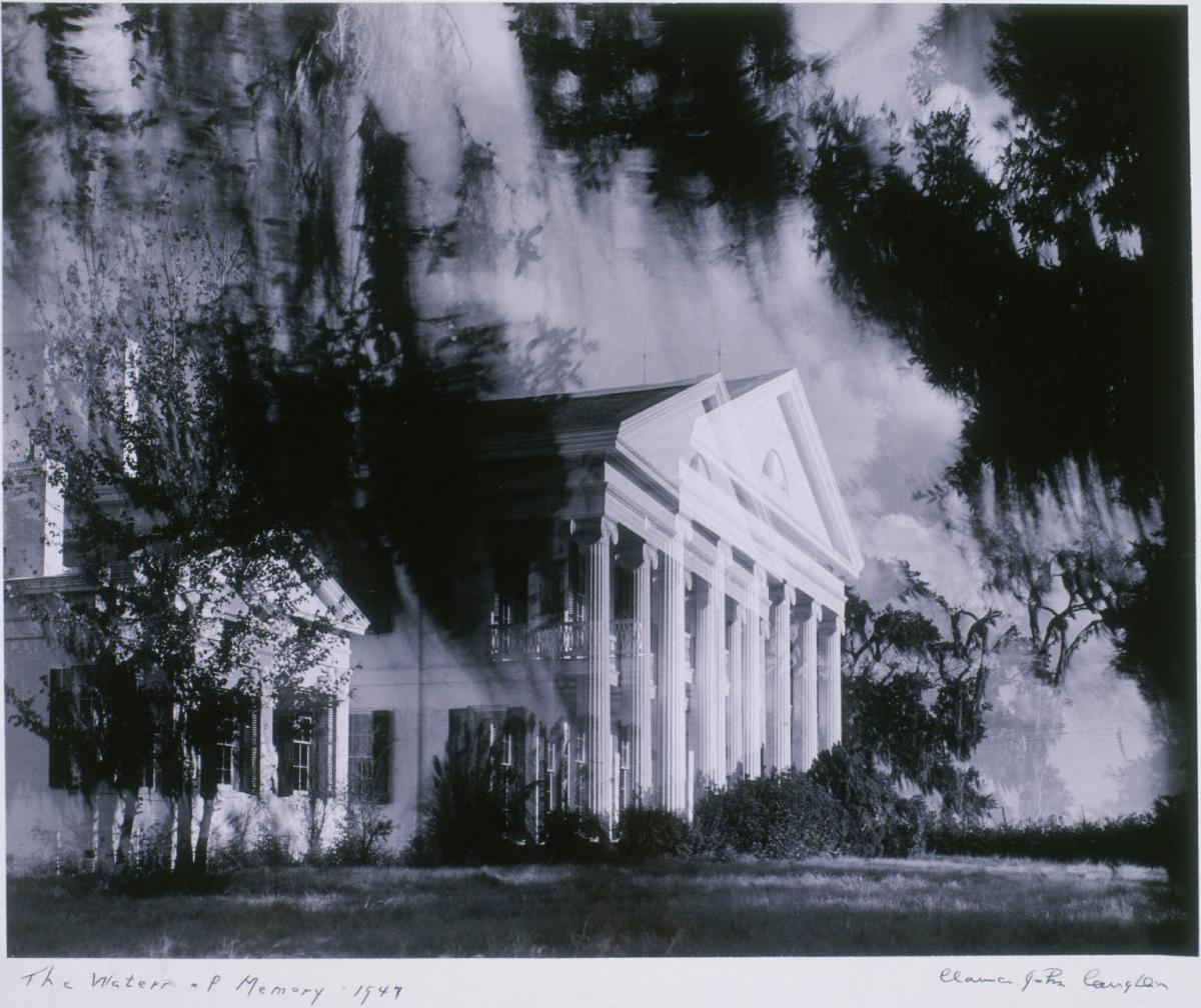 a black and white photograph that seems to be double exposed, of a stately white house