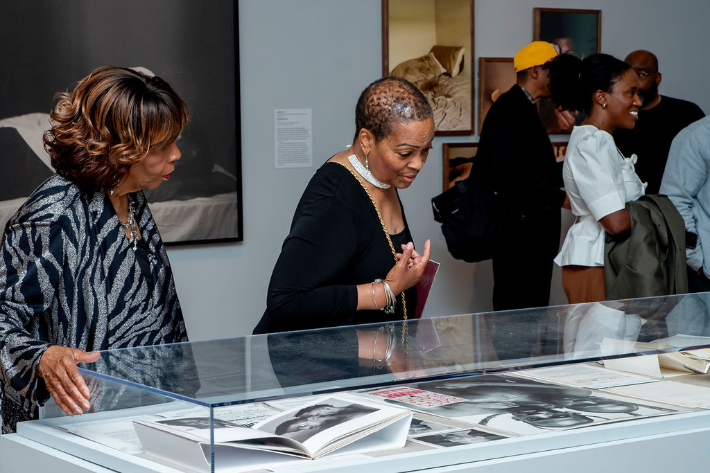 Essex Hemphill's mom and sister looking at the Take care of your blessings exhibition
