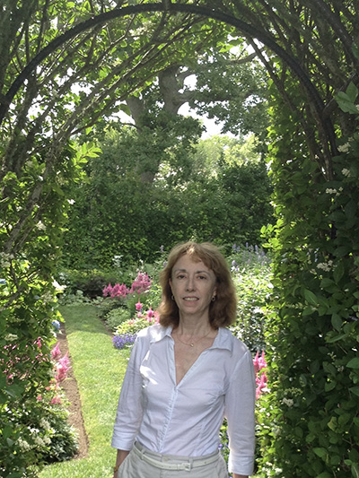 Photograph of Patricia Svoboda in a lush garden