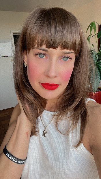 Photograph of Rachel Cecelski close to the camera with bright red lipstick