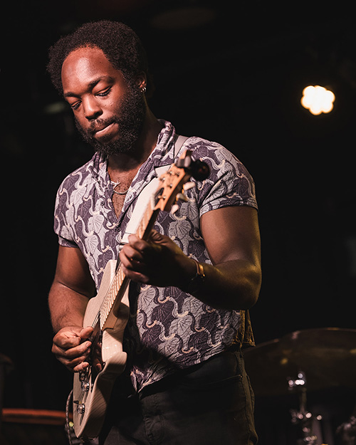 Noah Pierre playing a guitar