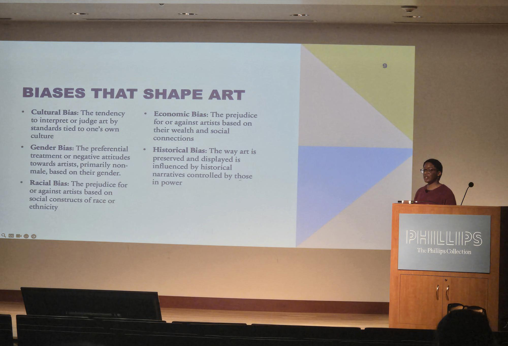 Trinitee Tatum giving a presentation on a stage