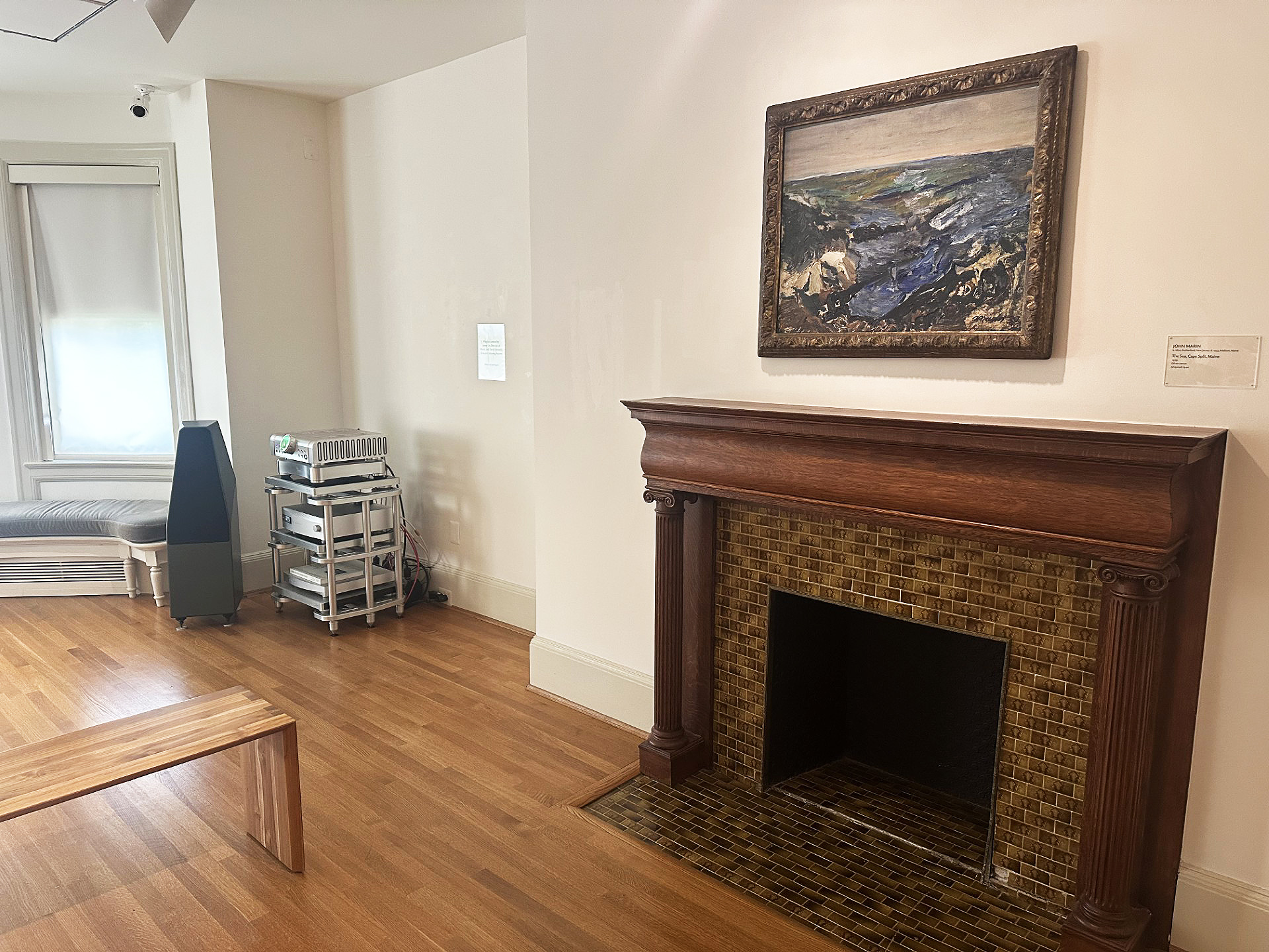 JS Audio speaker next to artwork over fireplace