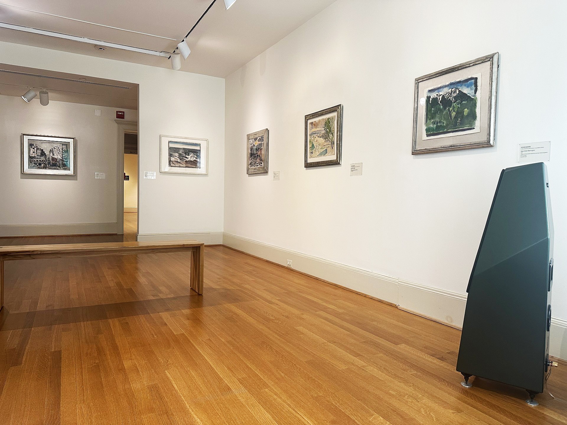 JS Audio speakers with five artworks on the wall