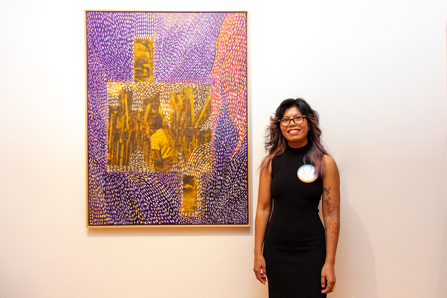 Khin standing next to her artwork