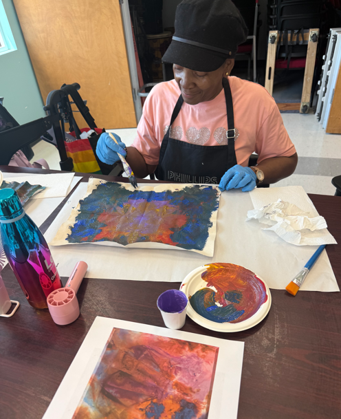 A person sitting at a table painting