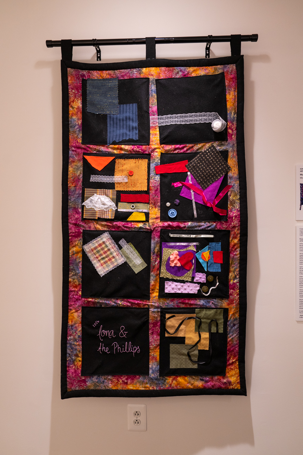 Quilt made of various shapes hanging on a wall