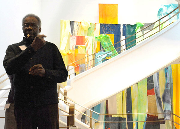 Sam Gilliam giving a talk in front of his work Flour Mill in the Goh Annex stairwell