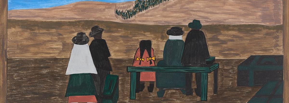 Families waiting at train station in front of open expanse