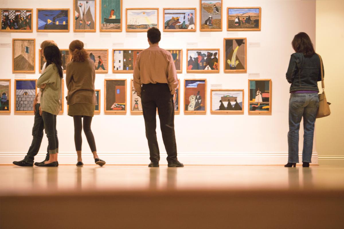 People looking at Jacob Lawrence's Migration Series