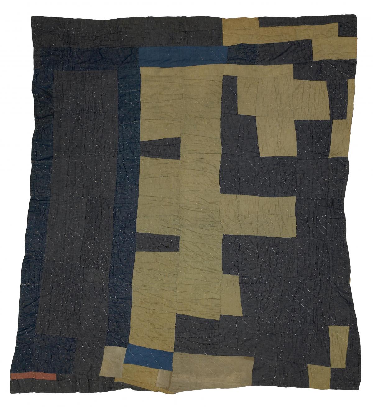 Quilt with dark gray-blue and tan geometric shapes