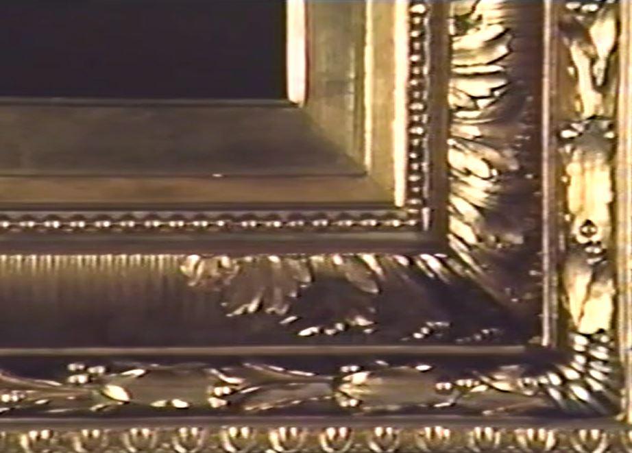 Photograph of a corner of an ornate gold frame