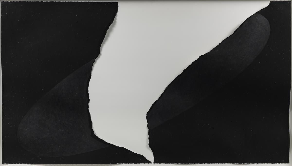Black paper with large white tear in middle