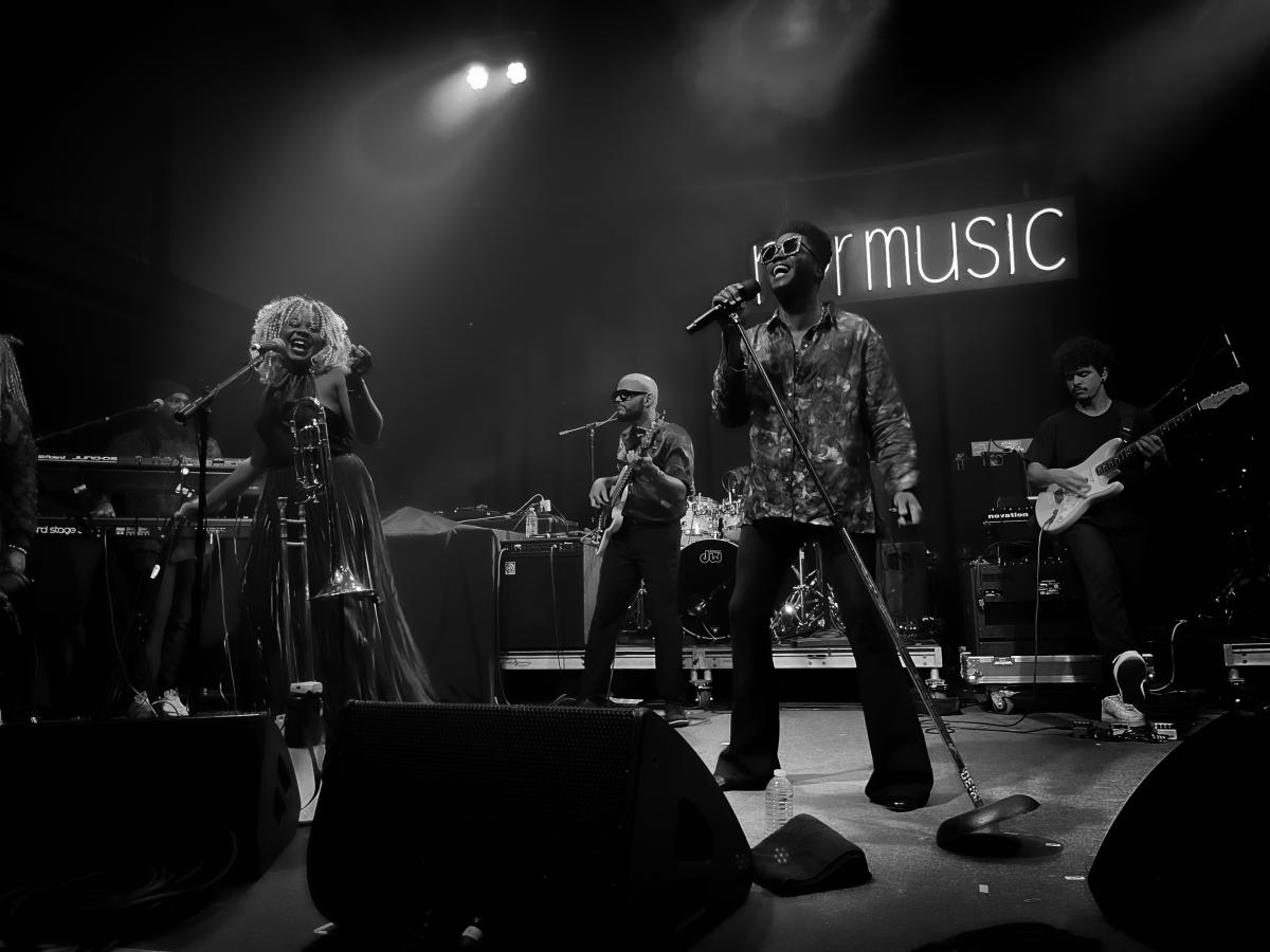 Black and white photograph of band playing on stage
