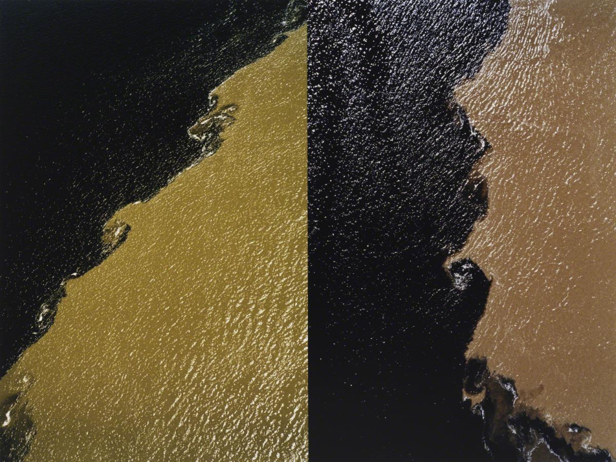 Color photograph of yellow, red, and black paint on a textured surface