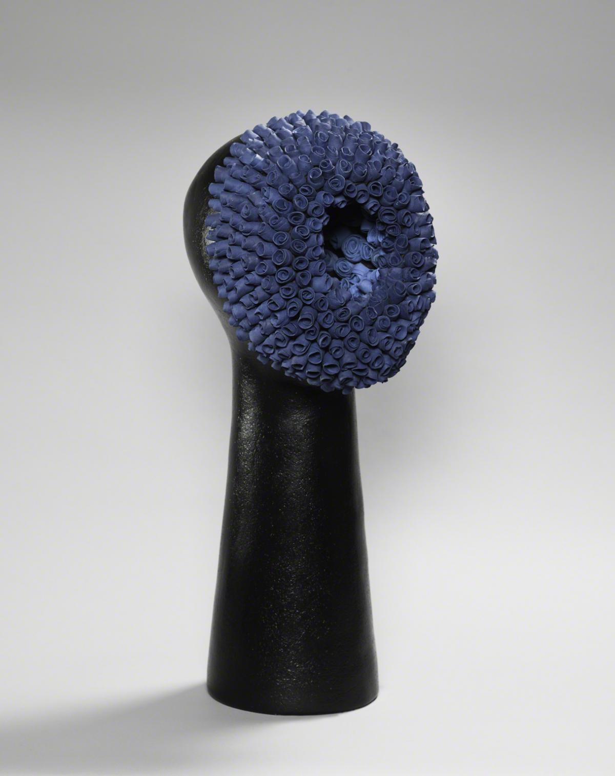 Sculpture of abstract head with blue roses