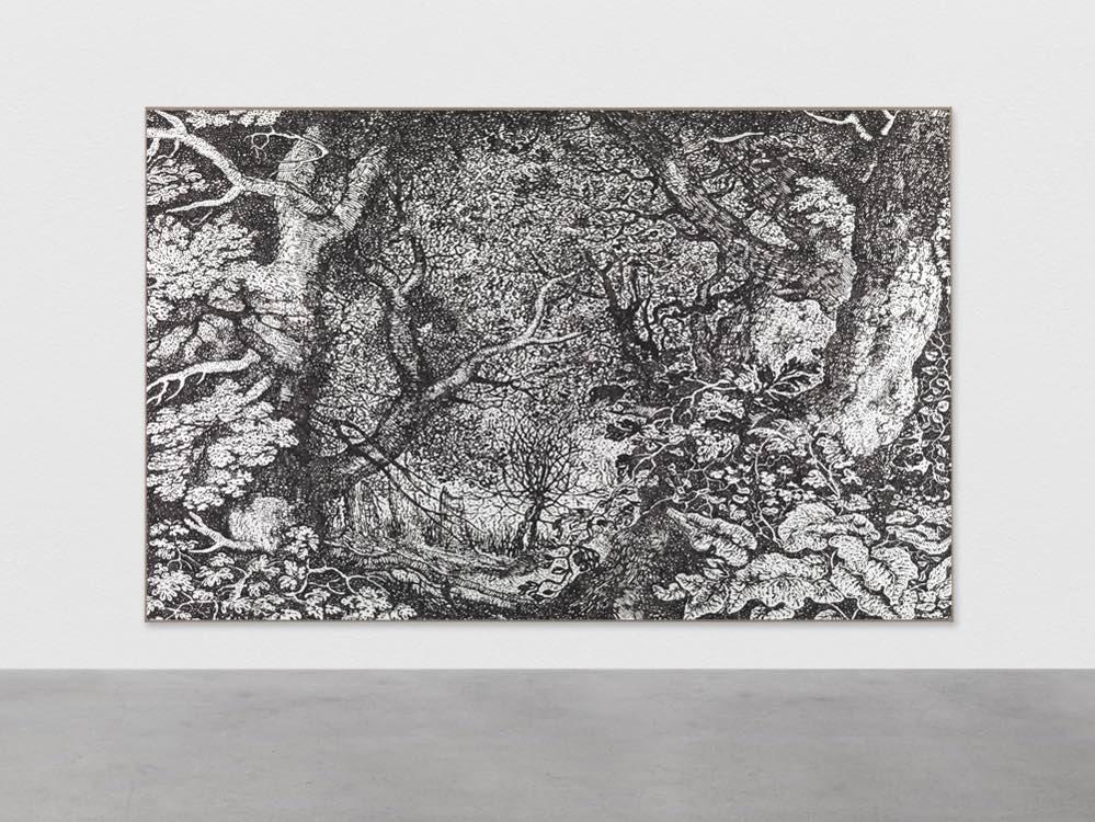 Photograph of large black-and-white artwork of forest hanging on gallery wall