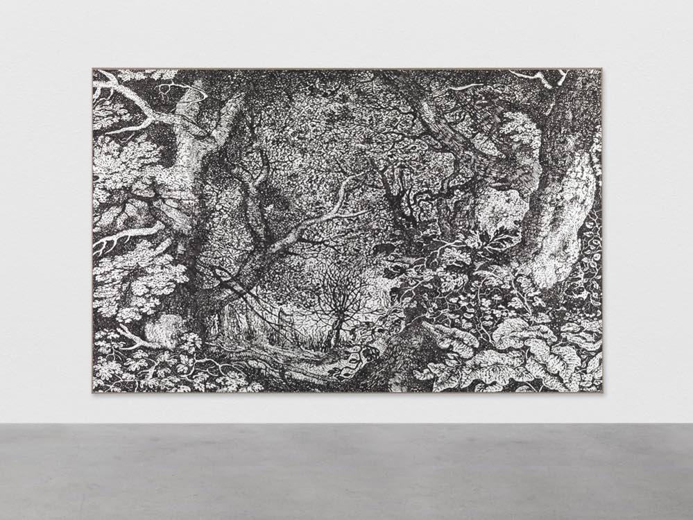 Photograph of large black-and-white artwork of forest hanging on gallery wall