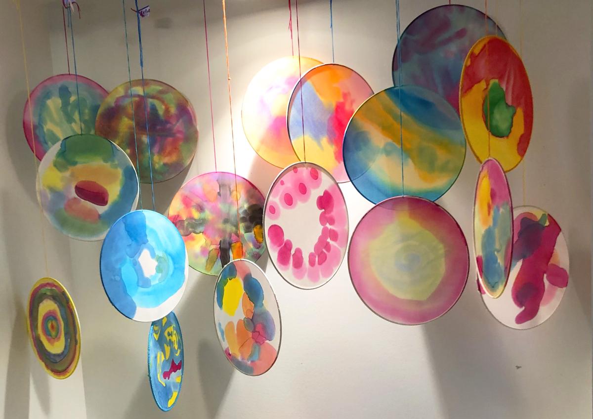 Photograph of colorful silk hoops hanging from ceiling