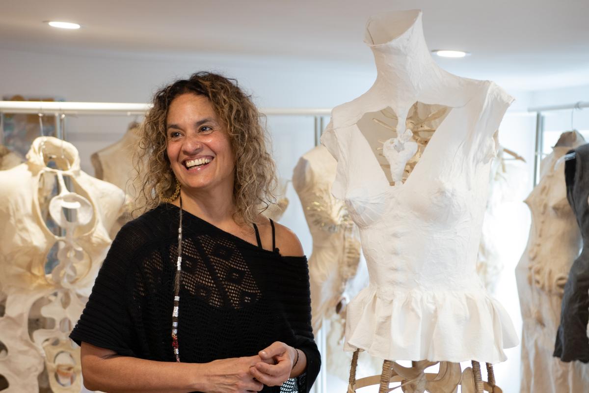 Photograph of Marta Perez Garcia in her studio with her paper sculpture torsos