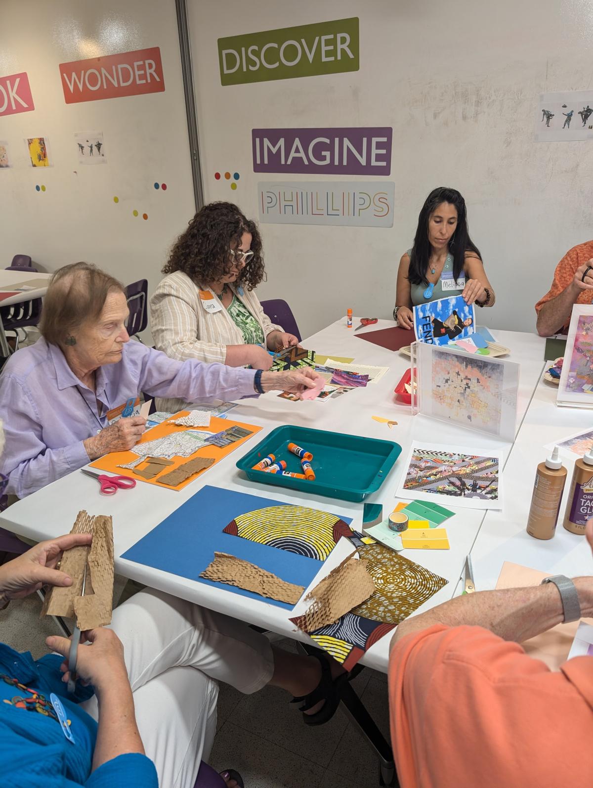 People sitting at a table making art