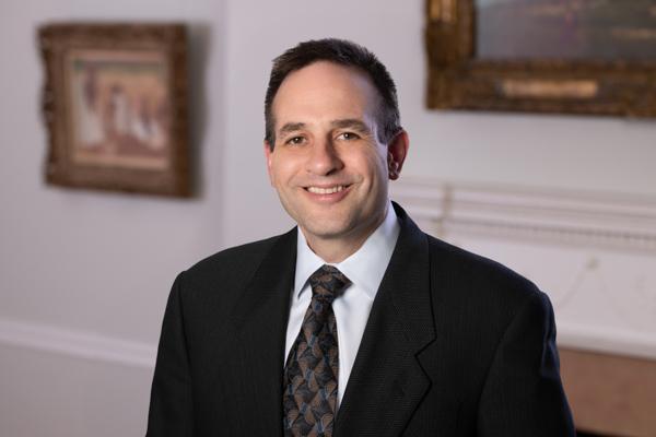 Man wearing a suit and tie smiling