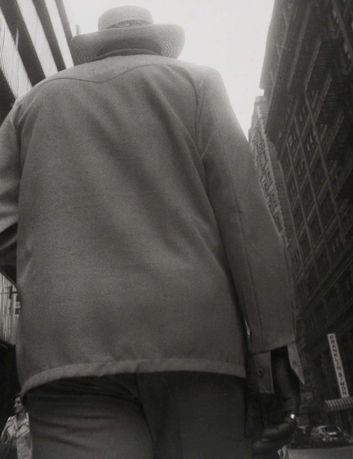 Leon Levinstein, Untitled (back view of man in hat), not dated.