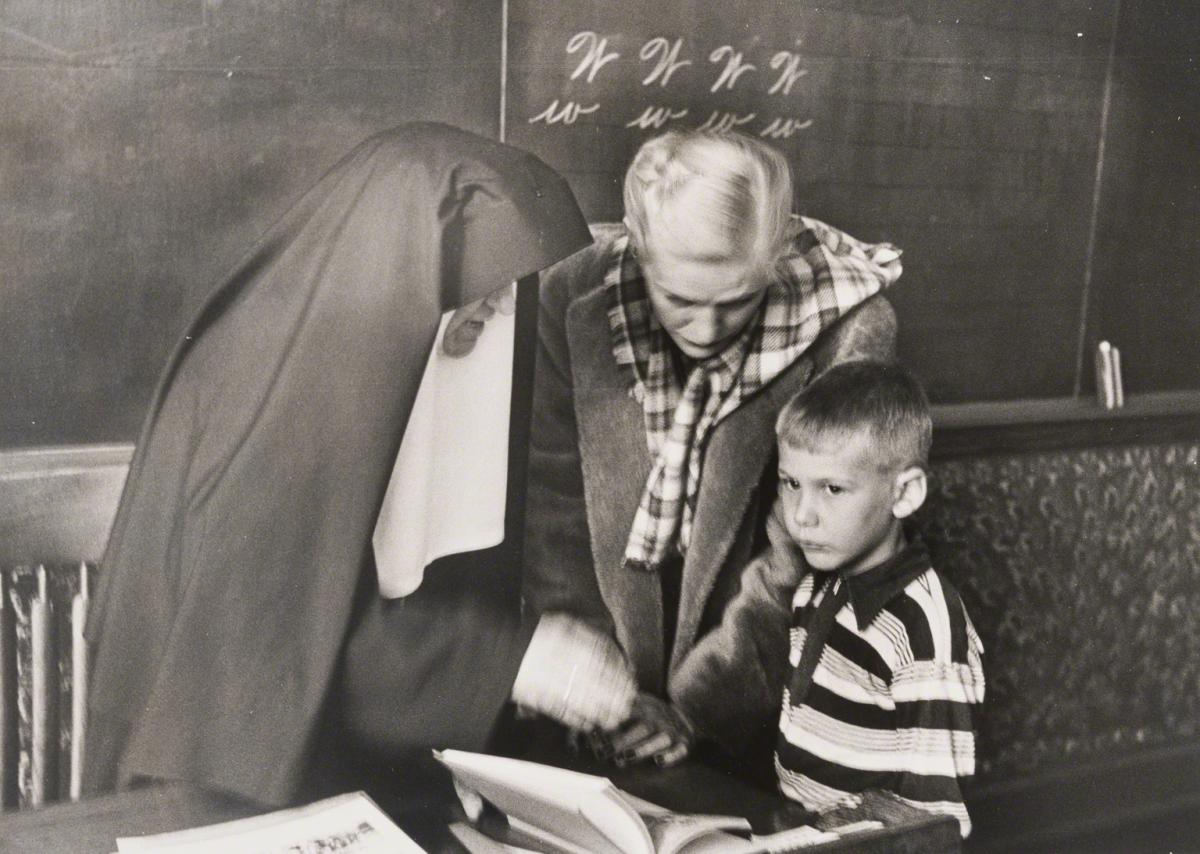 Esther Bubley, Untitled (mother and child with nun in classroom), c. 1950s.