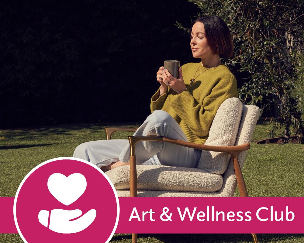 Eve Lewis meditating holding a mug sitting on a chair on a lawn