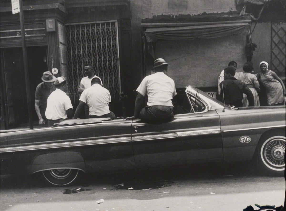 Leon Levinstein, Untitled (men in white shirts sitting on car), not dated.