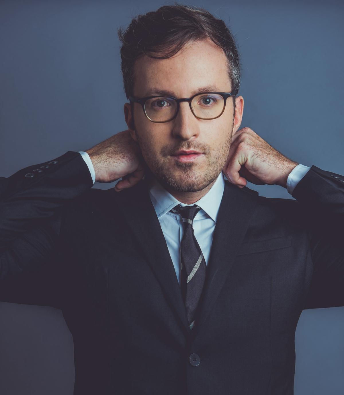 Photo of Conor Hanick wearing a suit
