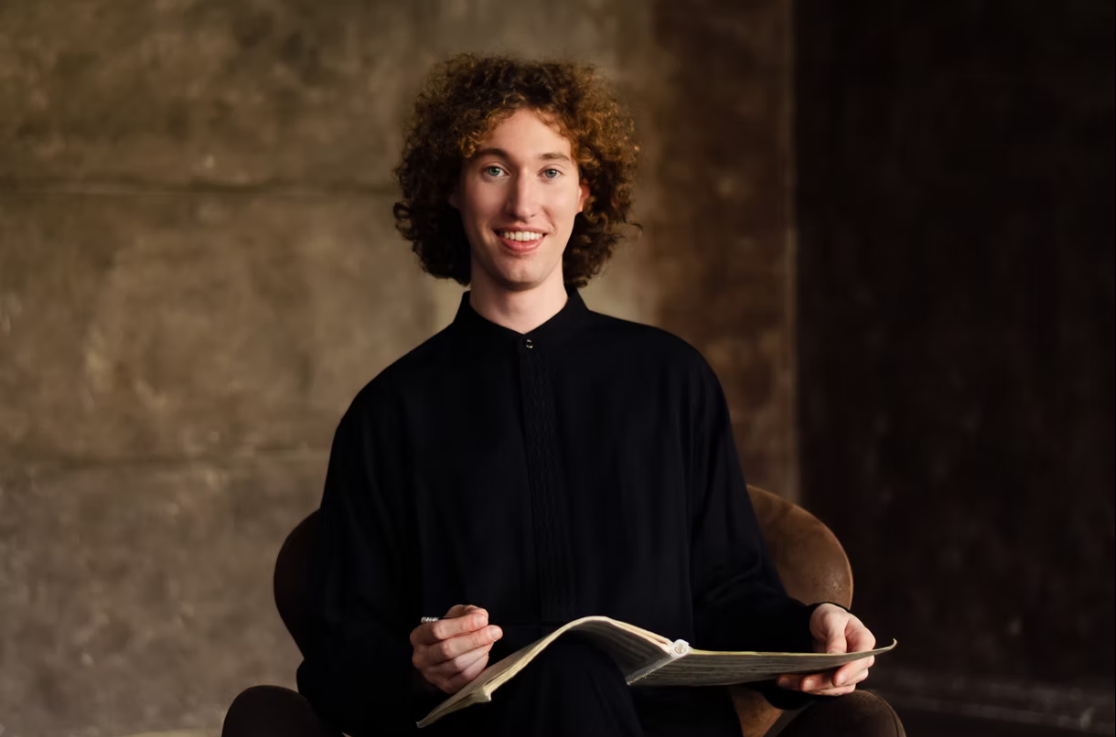 Michael Davidman holding a book