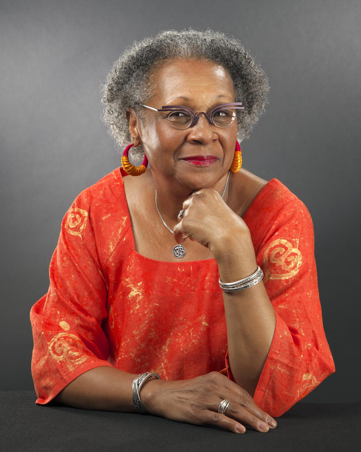 Photo of Imani Gonzalez wearing a red, leaning on table