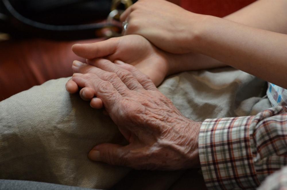 Close up image of two holding hands