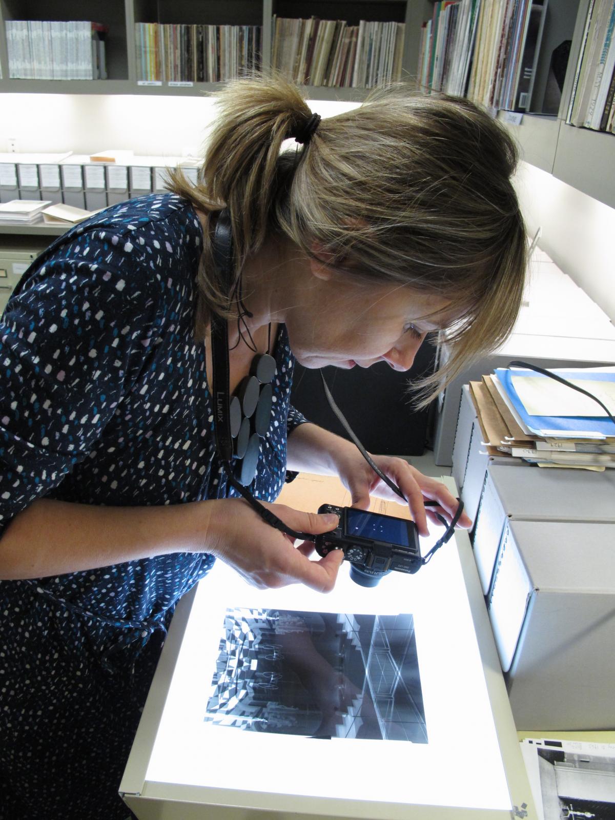 Vesna Pavlovic examining photographs in the Phillips archives