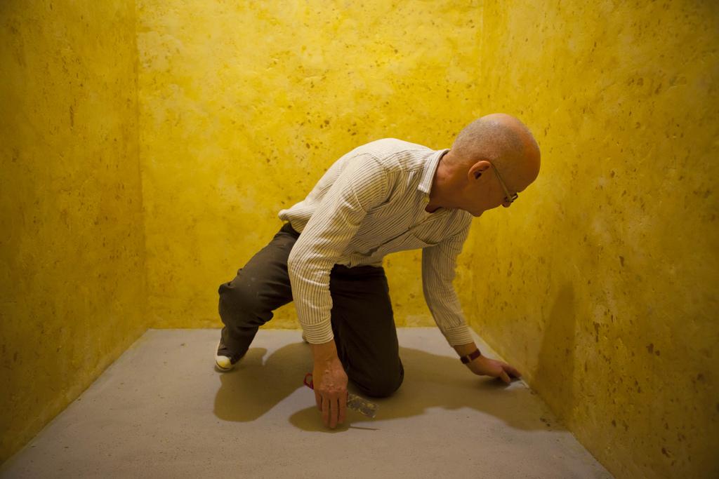 Wolfgang Laib installing the wax room at The Phillips Collection