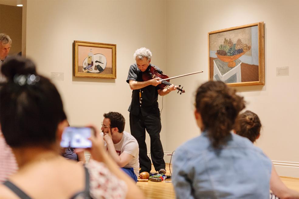 A musician performs in the gallery