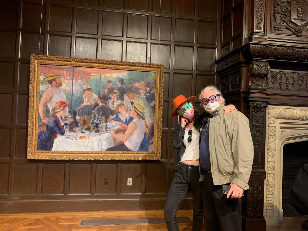 Photo of two people standing in front of Renoir's Luncheon of the Boating Party