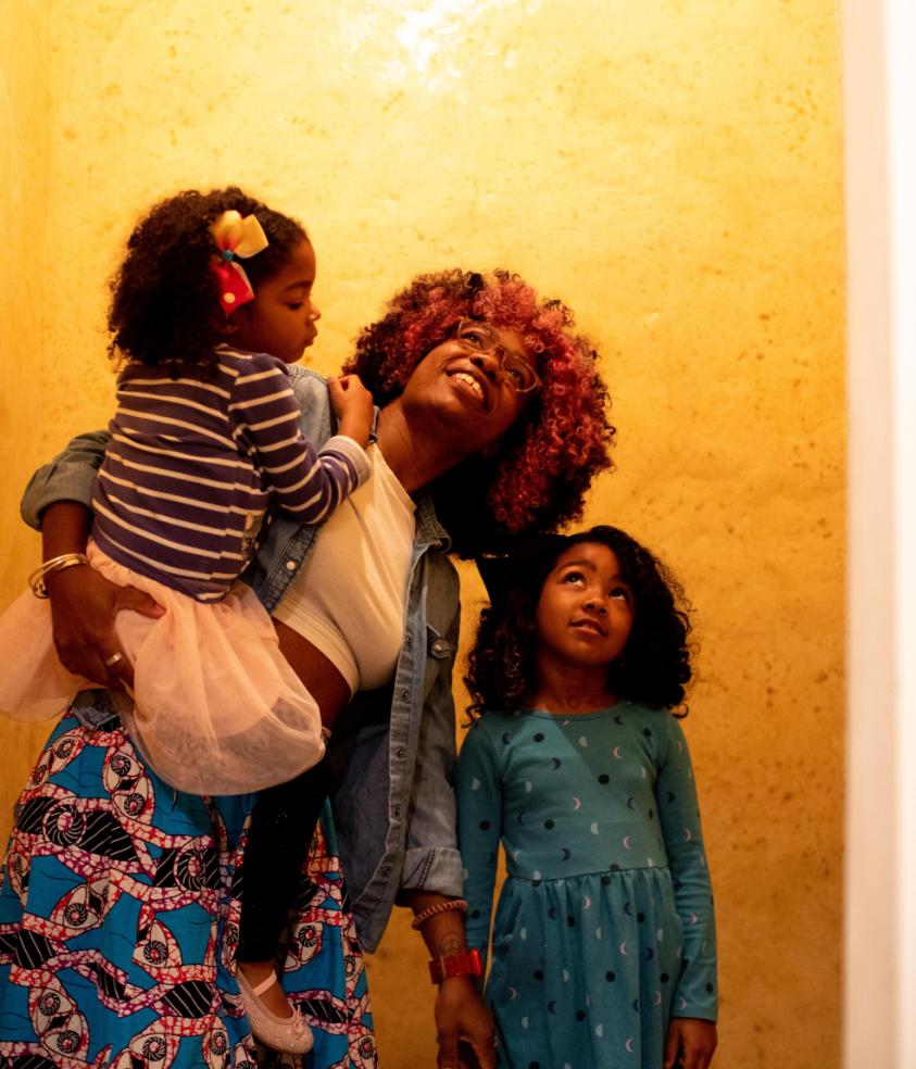 A parent with two children in the Wax Room
