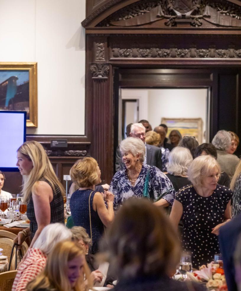 People mingling in the Music Room 