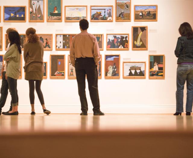 People looking at Jacob Lawrence's Migration Series