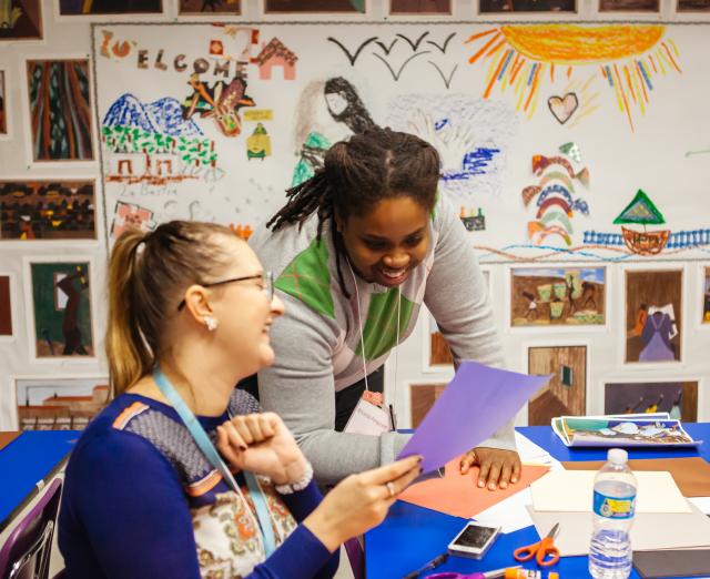 Photograph of two women smiling in a room with art supplies