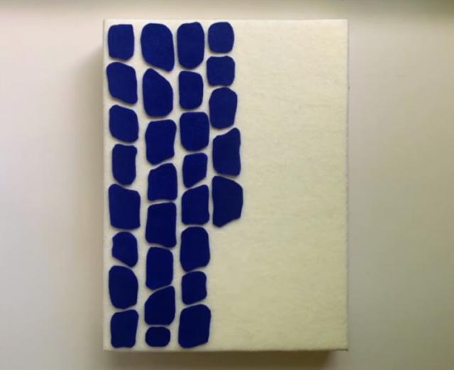 Photograph of small white canvas with blue felt in style of Alma Thomas stripe paintings