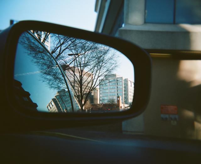 Image of a car's rearview mirror reflecting the city of DC
