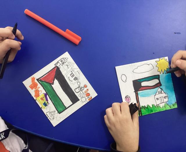 Photograph of two children's drawings of flags